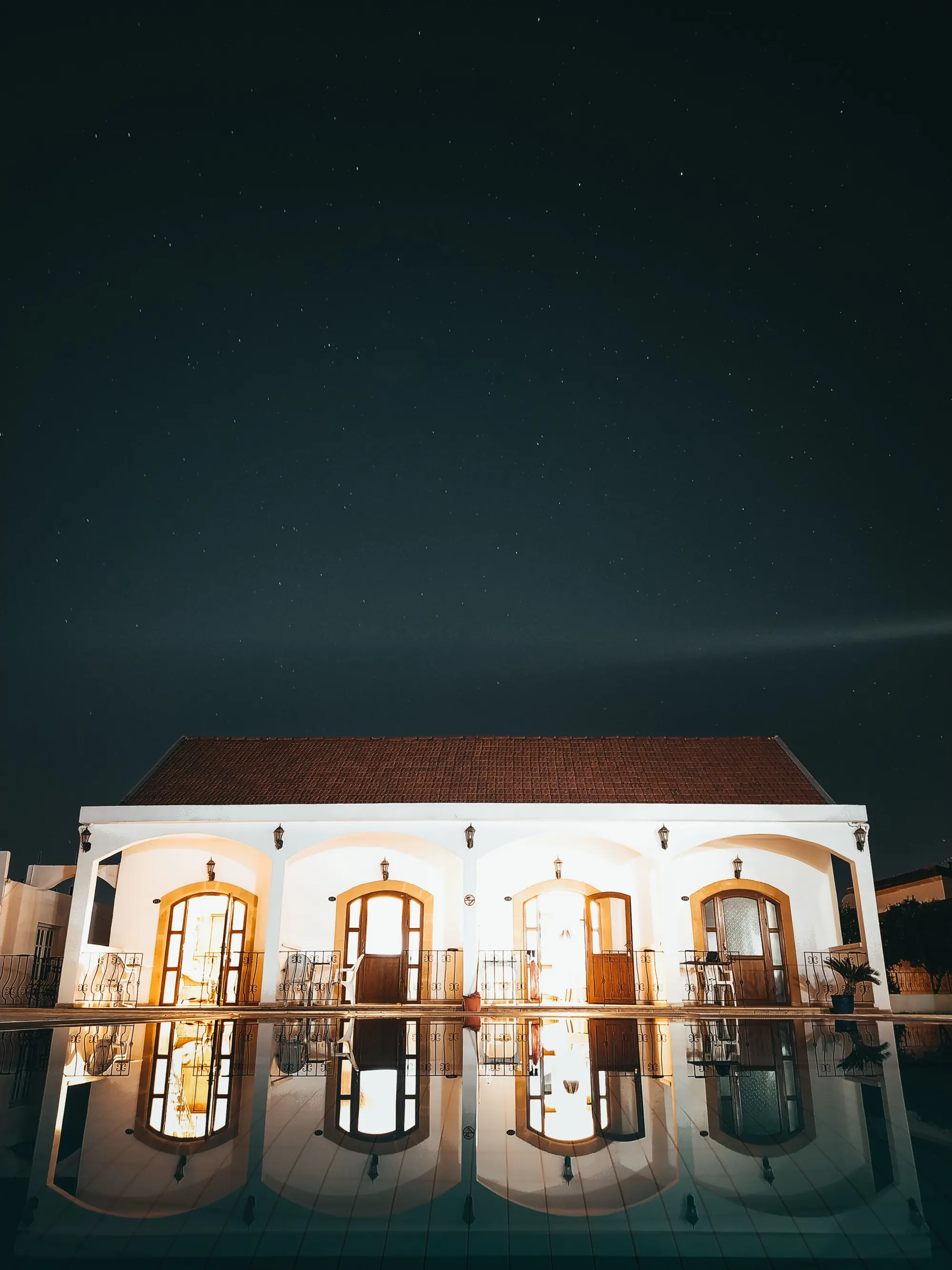 Villa reflected in its pool at night