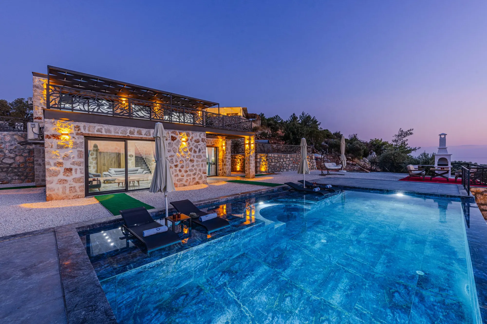 Waterfront villa with pool at dusk