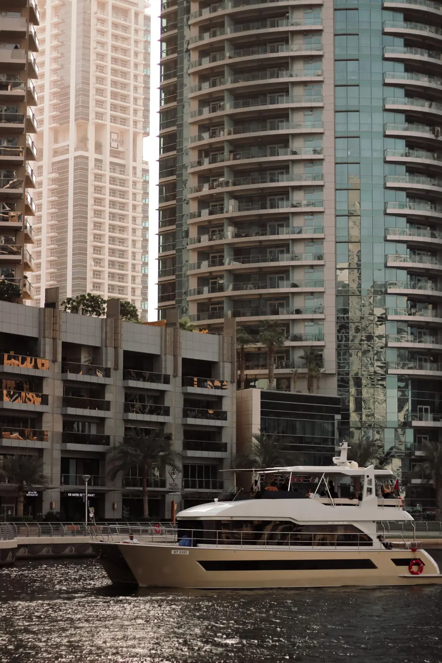 Yacht passing towers in Dubai Marina